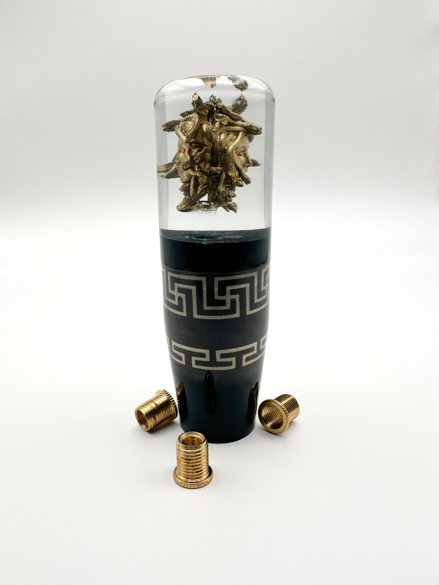 Oversized golden Medusa shift knob in clear resin with Versace-inspired design. 5.75" tall, weighted, and fits most manual and automatic cars.