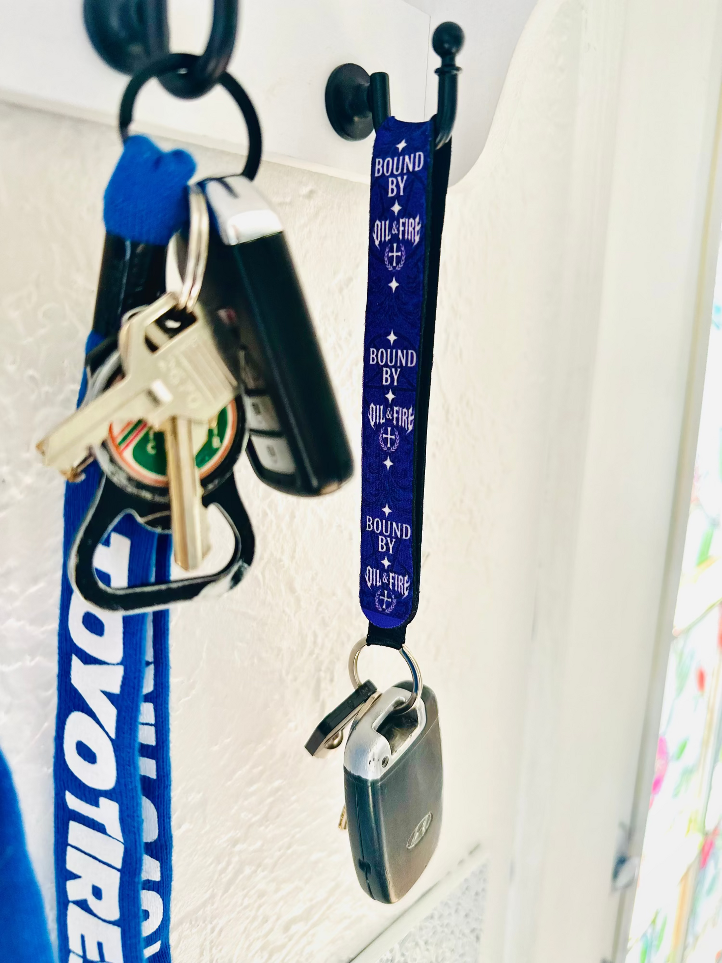 keychain that says bound by oil and fire haning