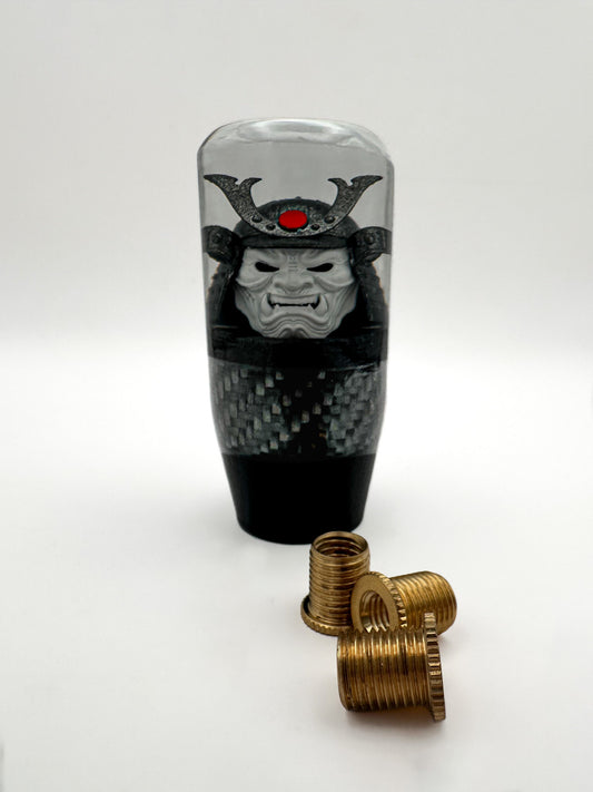 oni samurai shift knob, white face, gunmetal helmet, red accent. features real carbon fiber and black base. 
