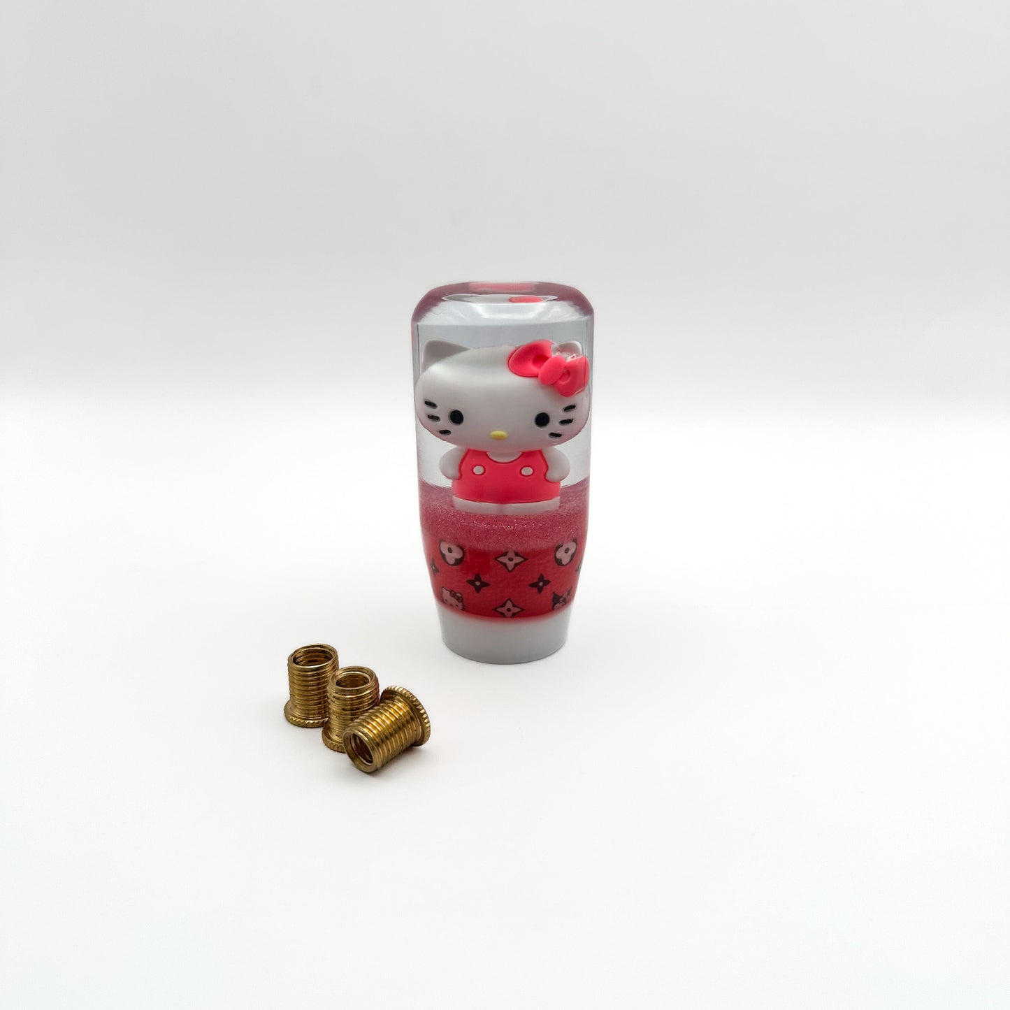 a shift knob featuring hello kitty and kuromi with a designer pattern pink girly shifter