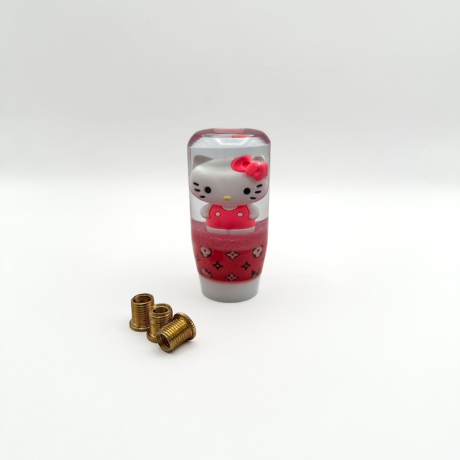 a shift knob featuring hello kitty and kuromi with a designer pattern pink girly shifter