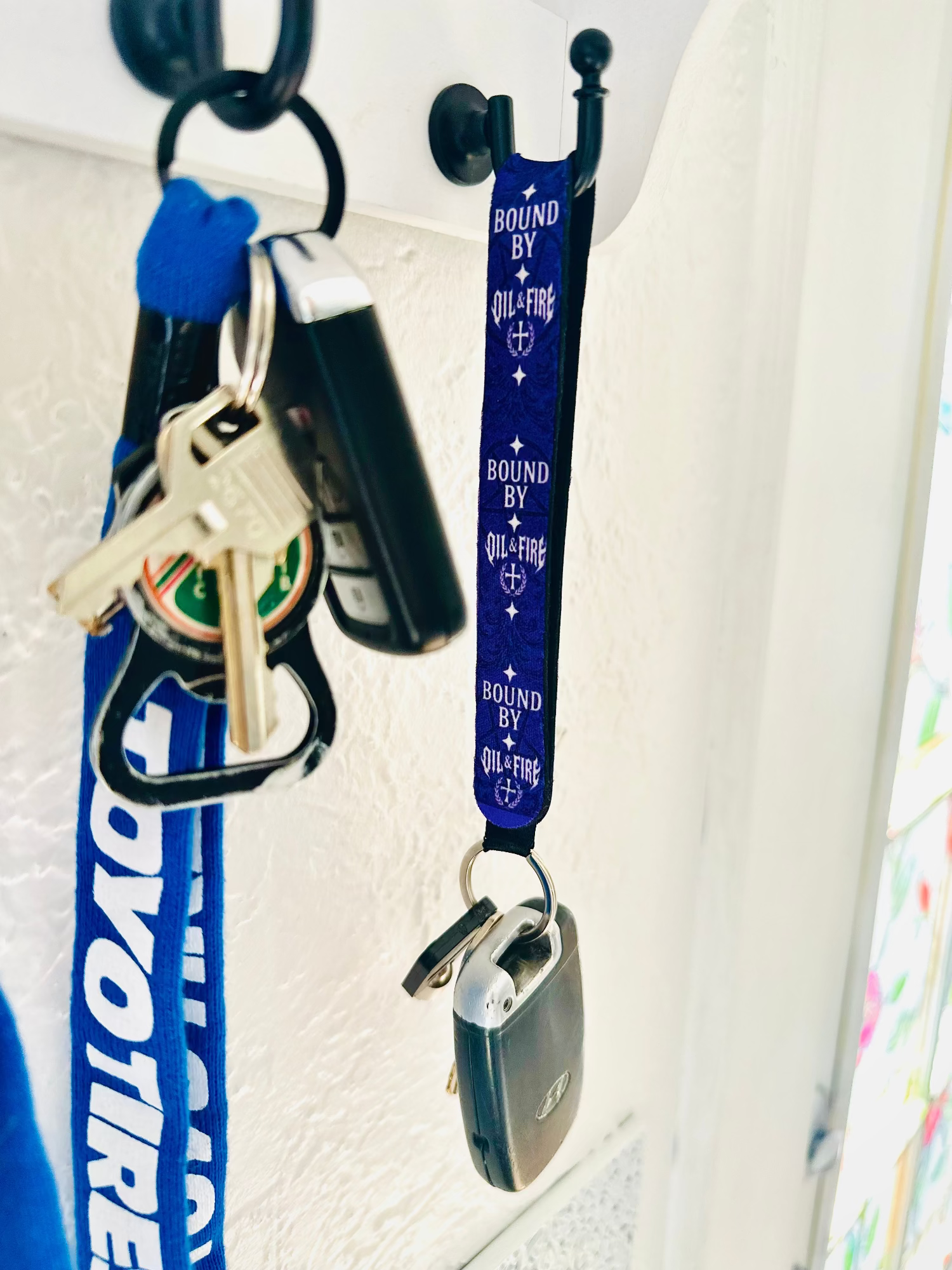 keychain that says bound by oil and fire haning