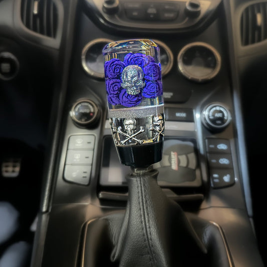 Chrome skull, purple rose shift knob installed in manual transmission car on the universal, custom gear shifter.