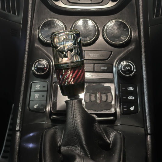 A Viking shift knob with red carbon fiber for custom universal and manual cars
